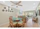 This living room has a dining space, tile flooring, ceiling fan and sliding door to a screened-in porch at 5665 Midnight Pass Rd # 410, Sarasota, FL 34242