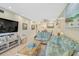 Cozy living room with beach-themed decor, rattan furniture, a ceiling fan, and a flat-screen TV at 5665 Midnight Pass Rd # 410, Sarasota, FL 34242