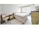 Neutral bedroom featuring comfortable furnishings, a window, and bright natural light at 5904 Palm Ln # C23, Bradenton, FL 34207