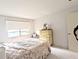 Cozy bedroom with a double bed, window letting in light, and a chest of drawers for storage at 5904 Palm Ln # C23, Bradenton, FL 34207