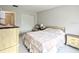 Bedroom featuring a full bed with a floral comforter, dresser, and ample closet space at 5904 Palm Ln # C23, Bradenton, FL 34207