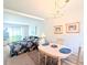 Cozy dining room featuring a charming chandelier, seating for four, and a tranquil view at 5904 Palm Ln # C23, Bradenton, FL 34207