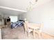 Dining room with chandelier that flows into the living area with floral sofa at 5904 Palm Ln # C23, Bradenton, FL 34207