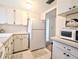 A corner view of the kitchen showcasing the refrigerator, microwave, and ample cabinet storage at 5904 Palm Ln # C23, Bradenton, FL 34207