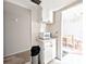 Cozy kitchenette area with white cabinets and view to dining area at 5904 Palm Ln # C23, Bradenton, FL 34207
