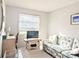Inviting living room with sofa, TV, and a bright window, creating a comfortable space to relax at 5904 Palm Ln # C23, Bradenton, FL 34207