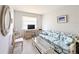 Cozy living room features a floral sofa, desk and chair, and neutral decor at 5904 Palm Ln # C23, Bradenton, FL 34207