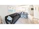 Comfortable living room with a floral sofa and artwork depicting a beach at 5904 Palm Ln # C23, Bradenton, FL 34207