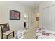 Relaxing bedroom with a floral comforter, chair, and view of the en-suite bathroom at 5925 Cessna Run, Bradenton, FL 34211