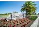 Entrance to the Lakewood National community with stone signage, landscaping, and palm trees at 5925 Cessna Run, Bradenton, FL 34211