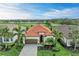 A beautiful one-story home with a tile roof, paved driveway, and lush landscaping on a golf course at 5925 Cessna Run, Bradenton, FL 34211