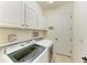 Bright laundry room features Samsung washer and dryer, custom shelving, and stylish decor at 5925 Cessna Run, Bradenton, FL 34211