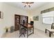 Home office with a wooden desk, bookcase, and neutral color scheme perfect for a productive workspace at 5925 Cessna Run, Bradenton, FL 34211