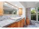 Bathroom featuring a stylish tiled counter and backsplash and a soaking tub under the window at 5954 River Forest Cir, Bradenton, FL 34203