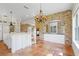 Large kitchen with white cabinets, central island, and brick accents, terracotta tile flooring at 5954 River Forest Cir, Bradenton, FL 34203