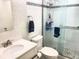 Modern bathroom featuring stylish glass-enclosed shower, white vanity, and decorative mosaic tile accents at 6157 Midnight Pass Rd # E42, Sarasota, FL 34242