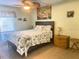 Bright bedroom featuring ceiling fan, coastal themed decor, and queen bed next to nightstand at 6157 Midnight Pass Rd # E42, Sarasota, FL 34242