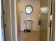 A warm foyer featuring a decorative mirror, console table, and tiled flooring at 6157 Midnight Pass Rd # E42, Sarasota, FL 34242