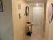 Hallway with tile floor, closet doors, and nautical wall decor at 6157 Midnight Pass Rd # E42, Sarasota, FL 34242