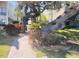 Beautifully landscaped path leading to the building with mature trees and vibrant shrubbery at 6157 Midnight Pass Rd # E42, Sarasota, FL 34242