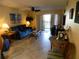 Cozy living room with comfortable seating and a sliding glass door to the balcony at 6157 Midnight Pass Rd # E42, Sarasota, FL 34242