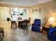 Cozy living room with tile flooring, dining area, and comfortable seating at 6157 Midnight Pass Rd # E42, Sarasota, FL 34242