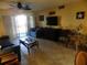 Comfortable living room with tile floors, opening onto balcony at 6157 Midnight Pass Rd # E42, Sarasota, FL 34242