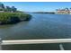 Scenic water view showcasing the serene waterfront, lush greenery, and clear skies at 6157 Midnight Pass Rd # E42, Sarasota, FL 34242