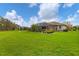 Lush backyard showcasing a screened-in patio and expansive green space at 6211 90Th Avenue E Cir, Parrish, FL 34219