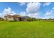 Scenic view of the backyard featuring a well-manicured lawn and screened-in patio at 6211 90Th Avenue E Cir, Parrish, FL 34219