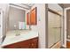 Bathroom with a sink, cabinetry, a large mirror and a shower with a glass door at 6211 90Th Avenue E Cir, Parrish, FL 34219