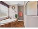 Bathroom with a soaking tub, a window with blinds, and decorative coastal themed decor at 6211 90Th Avenue E Cir, Parrish, FL 34219