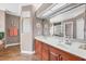Bathroom showcasing a large vanity, double sinks, a large mirror, and tile flooring at 6211 90Th Avenue E Cir, Parrish, FL 34219