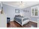 Bedroom with blue walls, a white bed frame, a ceiling fan, and hardwood floors at 6211 90Th Avenue E Cir, Parrish, FL 34219