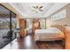 Bedroom featuring wood floors, trey ceiling, view of the pool and seating area at 6211 90Th Avenue E Cir, Parrish, FL 34219