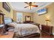 A bedroom featuring a bed, dresser, nightstand, flat screen TV, and dark wood floors at 6211 90Th Avenue E Cir, Parrish, FL 34219