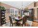 Dining room with wood table set, chandelier, built-in bar, and plantation shutters at 6211 90Th Avenue E Cir, Parrish, FL 34219