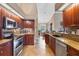 Contemporary kitchen showcasing stainless appliances, dark wood cabinets, and an efficient layout at 6211 90Th Avenue E Cir, Parrish, FL 34219