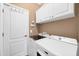 Well-equipped laundry room with a washer, dryer, and plenty of storage at 6211 90Th Avenue E Cir, Parrish, FL 34219