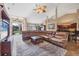 Open-concept living space featuring vaulted ceilings, a large sectional, and seamless access to the kitchen at 6211 90Th Avenue E Cir, Parrish, FL 34219
