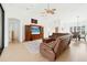 Bright living room with wood floors, ceiling fan, leather furniture, and entertainment center at 6211 90Th Avenue E Cir, Parrish, FL 34219