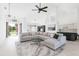 Modern living room with high ceilings, gray sectional, and natural light from front entrance at 6211 90Th Avenue E Cir, Parrish, FL 34219