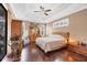 This main bedroom features dark wood floors, tray ceilings, and sliding glass doors to the pool area at 6211 90Th Avenue E Cir, Parrish, FL 34219