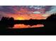 Picturesque pond reflecting a vibrant sunset with cloudscape backdrop enhancing natural beauty at 6211 90Th Avenue E Cir, Parrish, FL 34219
