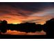 Scenic pond view at sunset with fiery sky reflections over a serene landscape at 6211 90Th Avenue E Cir, Parrish, FL 34219