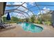 Sparkling pool is surrounded by a screened-in lanai, lounge chairs, and lush landscaping creating a private outdoor oasis at 6211 90Th Avenue E Cir, Parrish, FL 34219