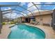 Inviting in-ground pool with a screened enclosure, complemented by patio furniture perfect for outdoor relaxation and entertainment at 6211 90Th Avenue E Cir, Parrish, FL 34219