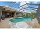Inviting in-ground pool with a screened enclosure, complemented by patio furniture perfect for outdoor relaxation and entertainment at 6211 90Th Avenue E Cir, Parrish, FL 34219