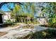 Landscaped backyard with stone walkways, bamboo, a decorative bird bath, and a shed at 635 Ohio Pl, Sarasota, FL 34236