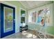 Bright entryway with a view of a lush, green tree with a painting of a Personal on a easel at 635 Ohio Pl, Sarasota, FL 34236